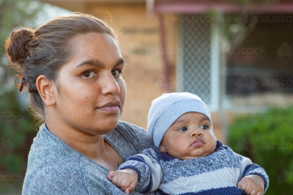 Young mother holding her baby outside - Australian Stock Image