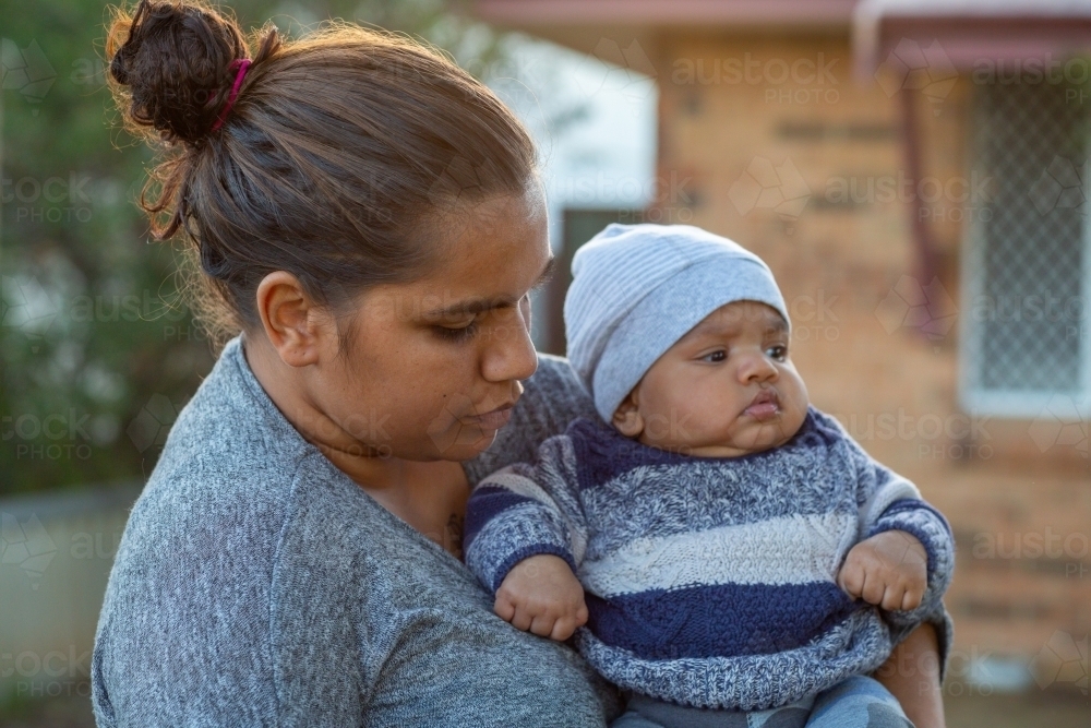 Young mother holding her baby outside - Australian Stock Image