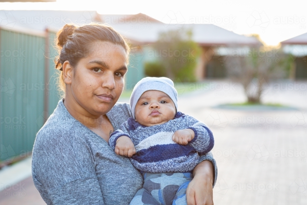 Young mother holding her baby outside - Australian Stock Image