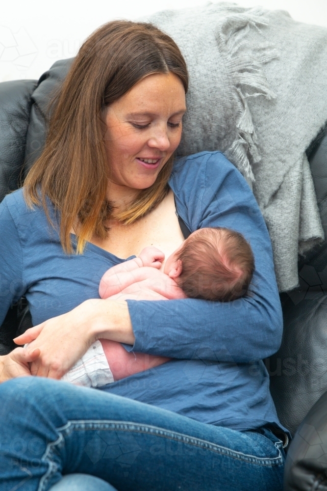 Young mother nursing a newborn baby - Australian Stock Image