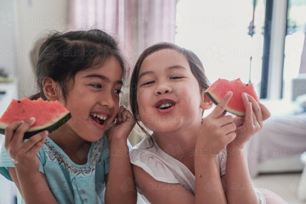 Young multicultural girls having watermelon in summer - Australian Stock Image