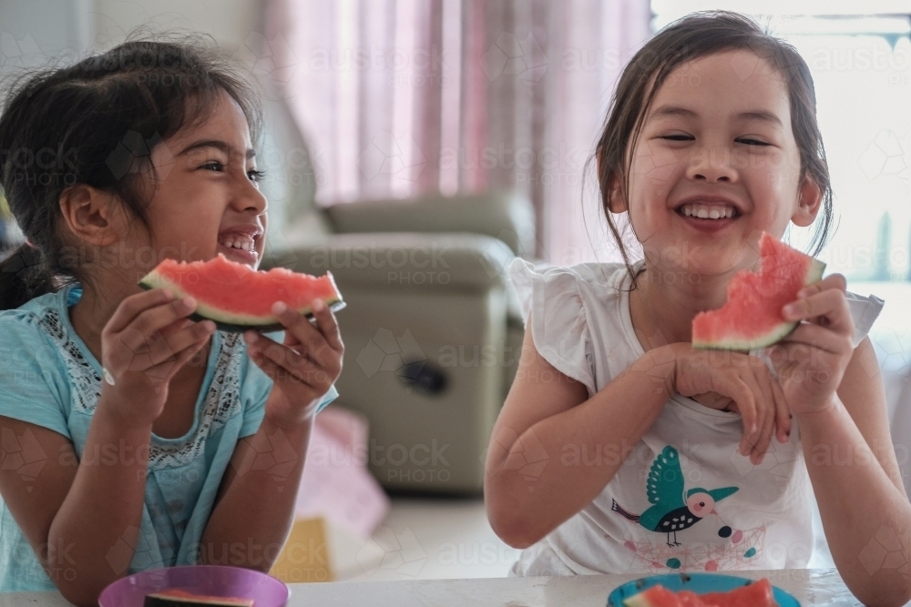 Young multicultural girls having watermelon in summer - Australian Stock Image