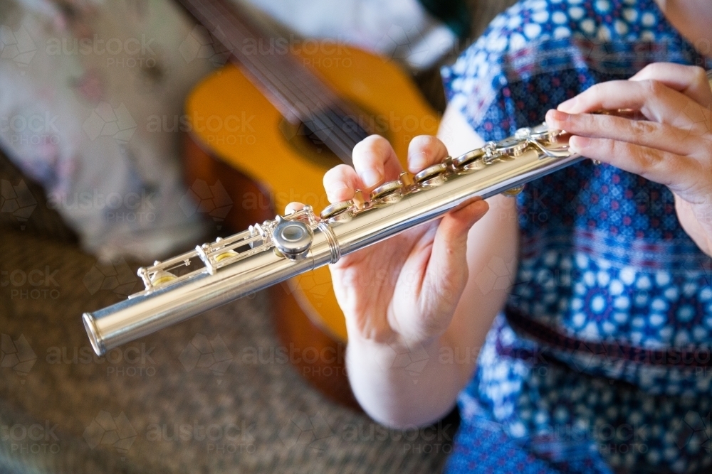 Young musical lady playing a flute - Australian Stock Image