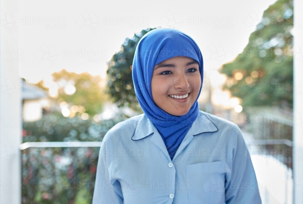 Young Muslim High School student laughing on-campus - Australian Stock Image