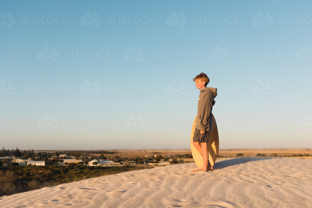 Young Person Standing on a White Sand Dune Overlooking the Australian Outback Landscape - Australian Stock Image