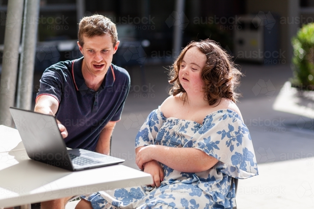 young person with disability doing one on one activity with her NDIS provider - Australian Stock Image