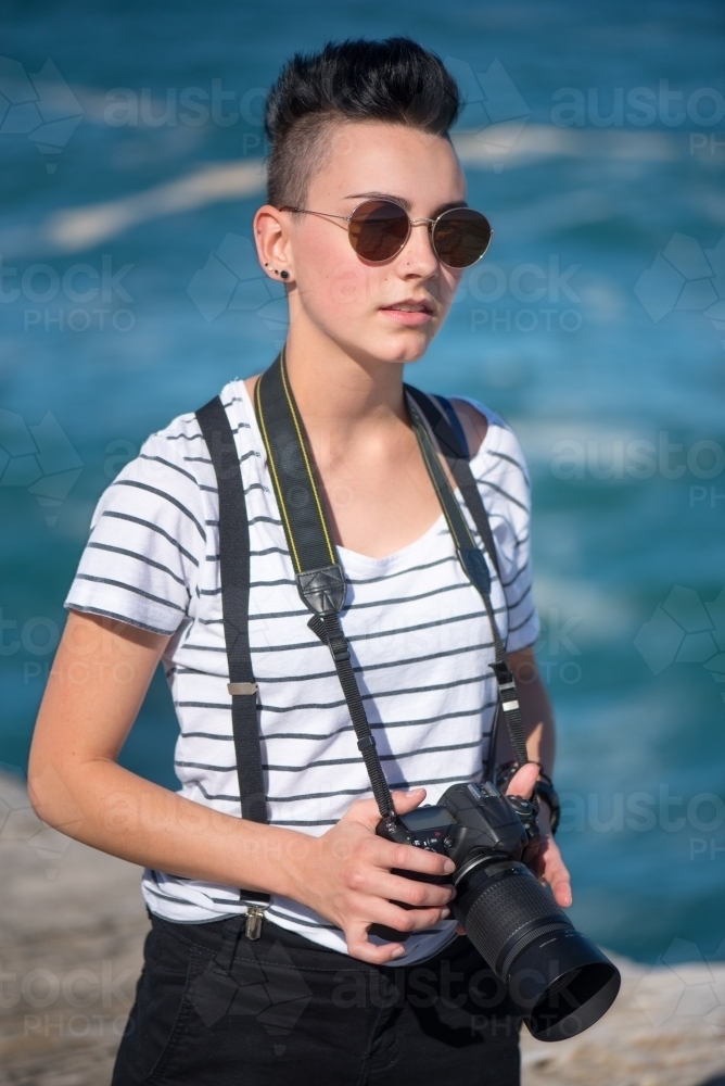Young photographer with sunglasses - Australian Stock Image