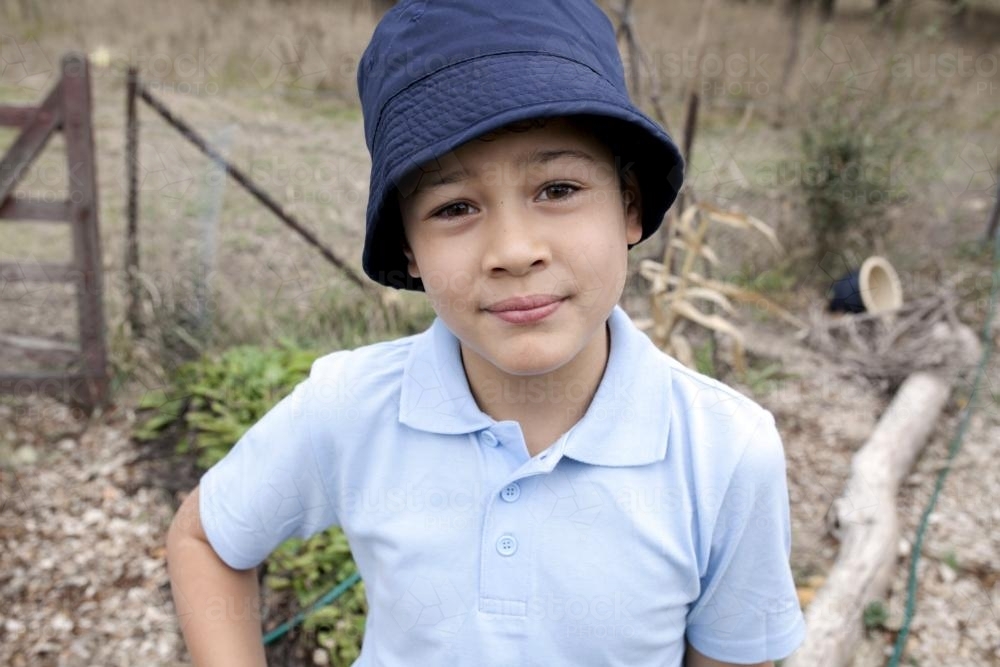 Young polynesian school boy wearing uniform looking at camera - Australian Stock Image