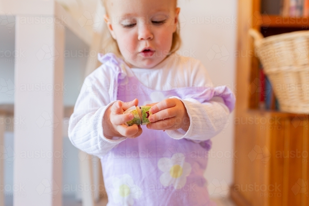 Image of Young preschool aged child playing with native australian bird nesting doll toy