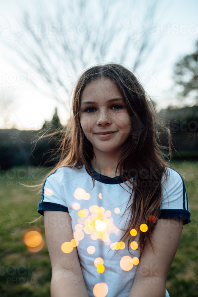 Young preteen girl holding a sparkler in the garden - Australian Stock Image