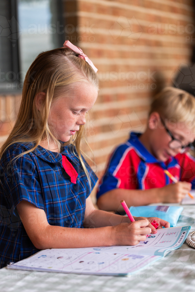 Image of Young primary school student working on homework after school ...