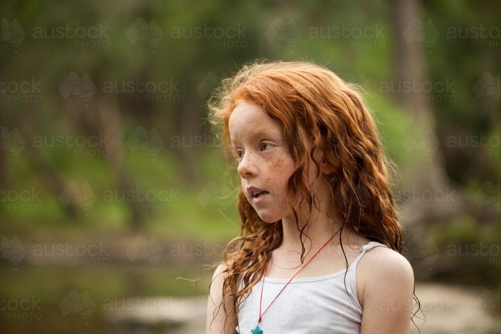 Young redhead girl by the riverside - Australian Stock Image