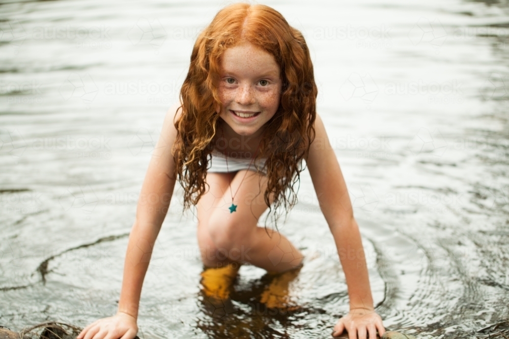 Young redheaded girl by the riverside - Australian Stock Image