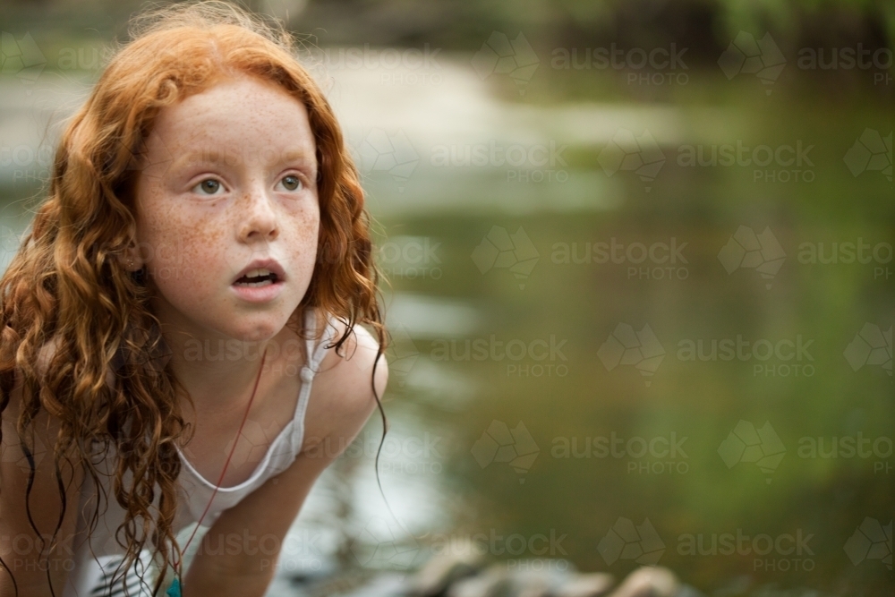 Young redheaded girl by the riverside - Australian Stock Image