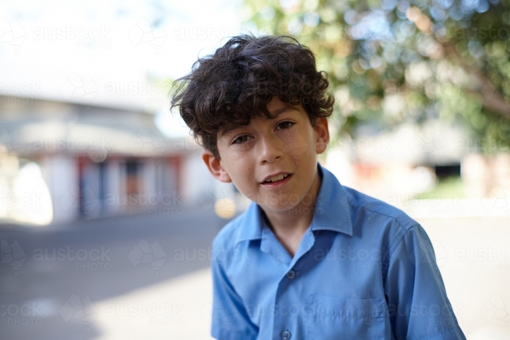 Young school boy making playful expression - Australian Stock Image