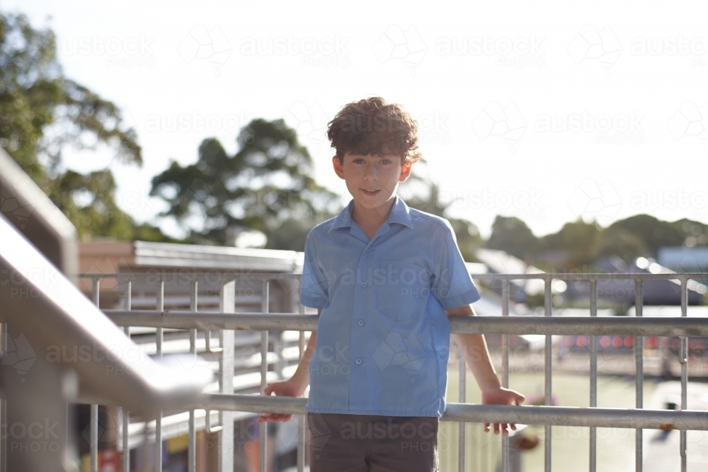 Young school boy on stairs at school - Australian Stock Image