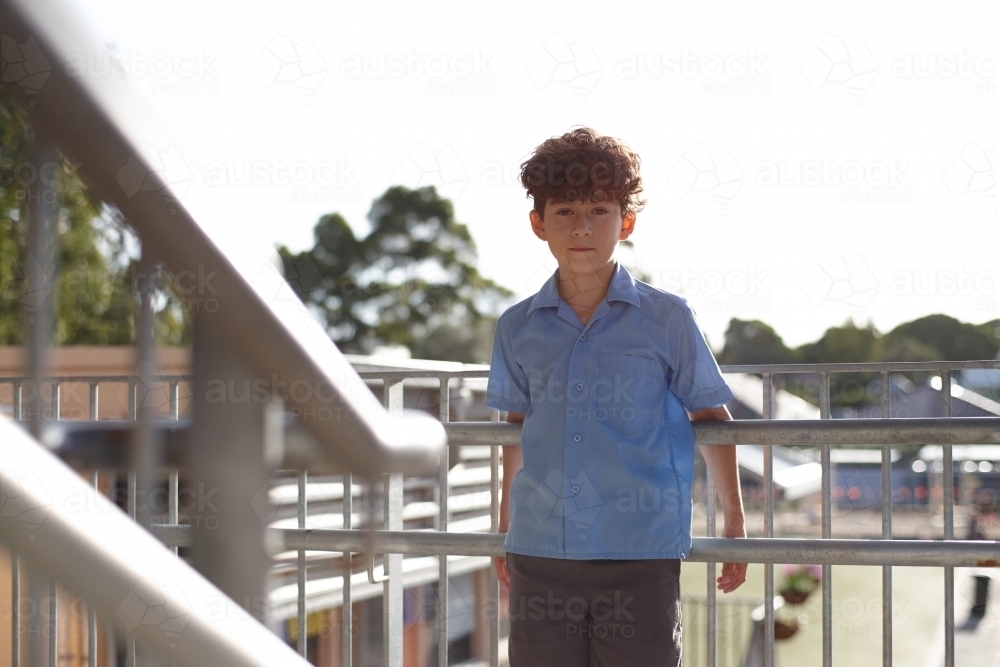 Young school boy on stairs at school - Australian Stock Image