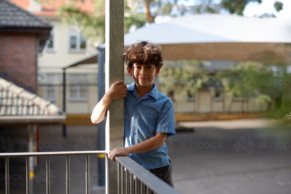 Young school boy smiling at school playground - Australian Stock Image