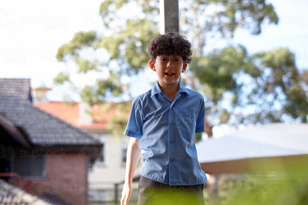 Young school boy talking at school grounds - Australian Stock Image