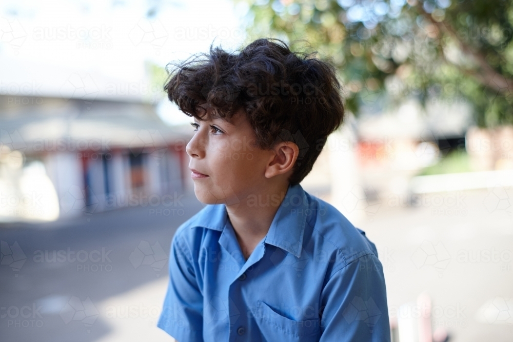 Young school boy thinking looking afar - Australian Stock Image