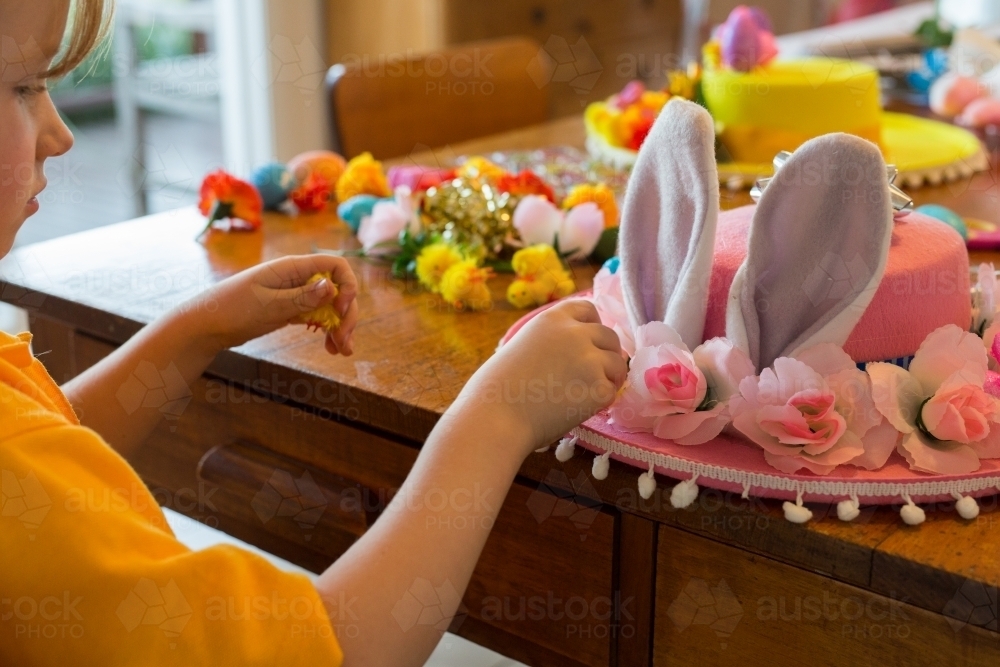 Young school girl making a hat for an Easter hat parade - Australian Stock Image