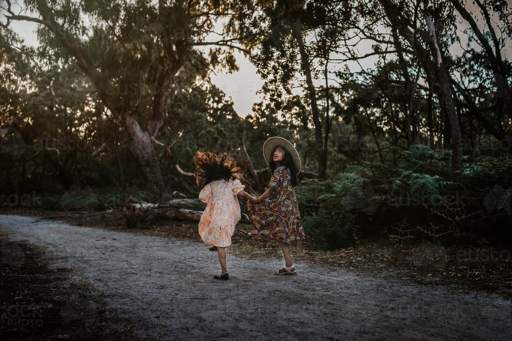 Young siblings walking in the park - Australian Stock Image