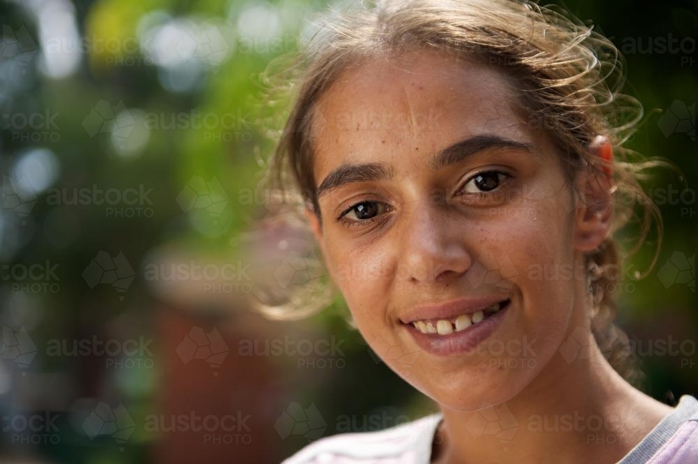 Young Smiling Aboriginal Woman on Blurred Background - Australian Stock Image