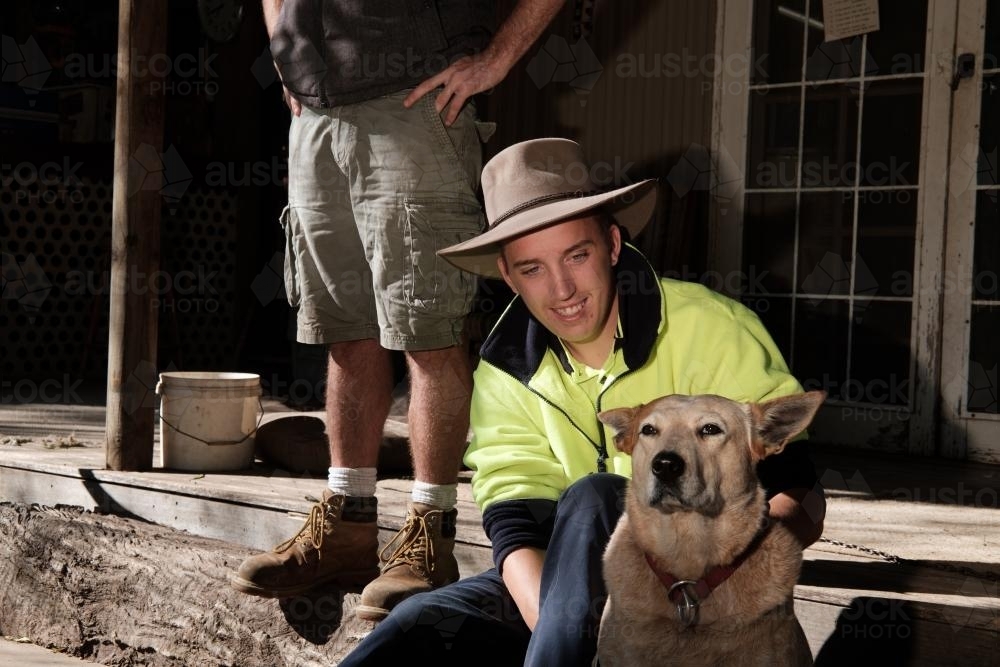 Young Stockman with a Red Heeler - Australian Stock Image