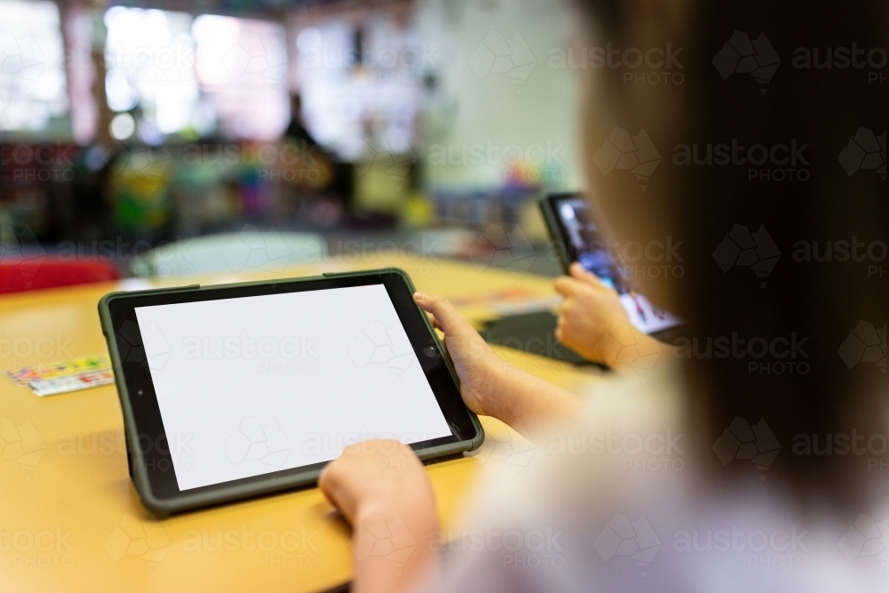 Young student using iPad in classroom - Australian Stock Image
