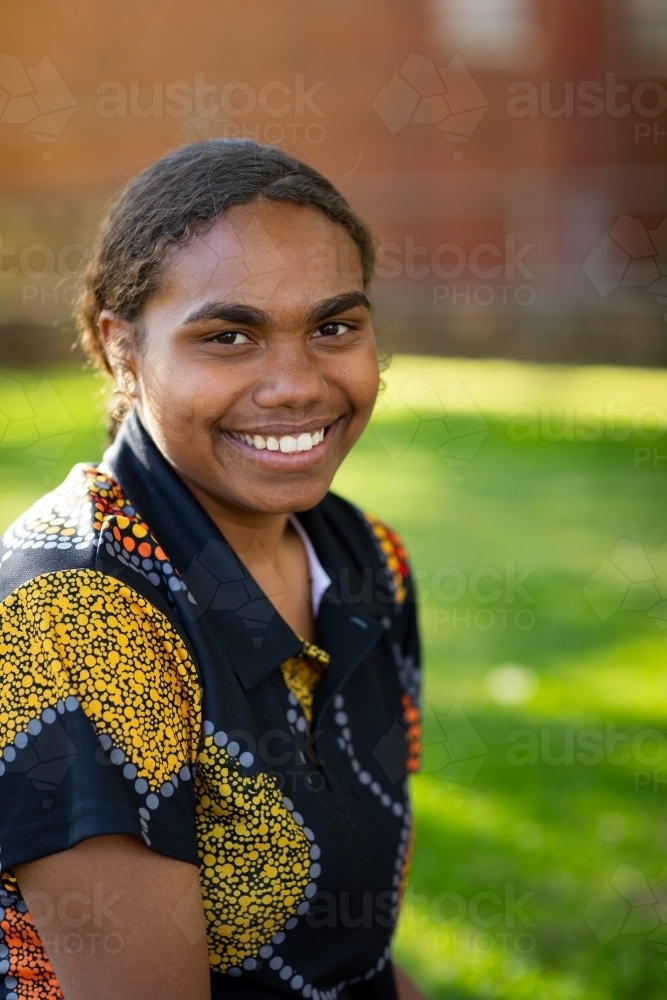 young teen girl outside with dappled shade - Australian Stock Image