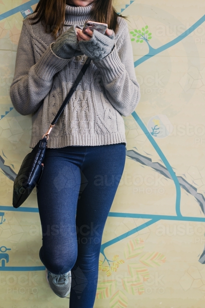 young teen using mobile phone, anonymous - Australian Stock Image