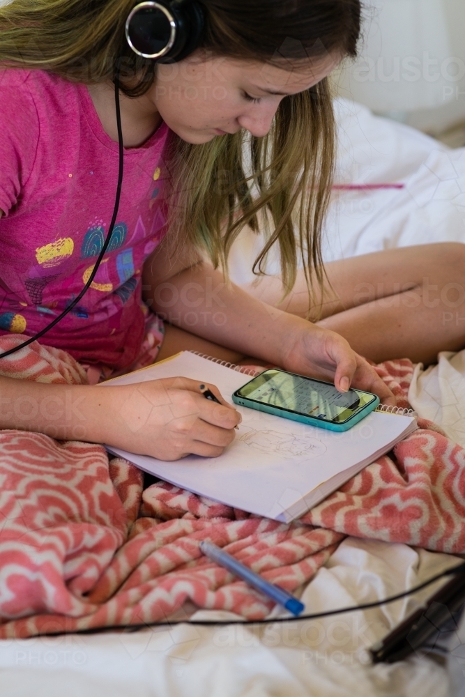 young teen using technology to learn drawing - Australian Stock Image