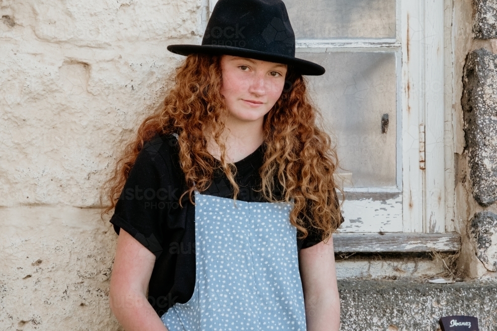 Young teen wearing a hat and looking at the camera. - Australian Stock Image