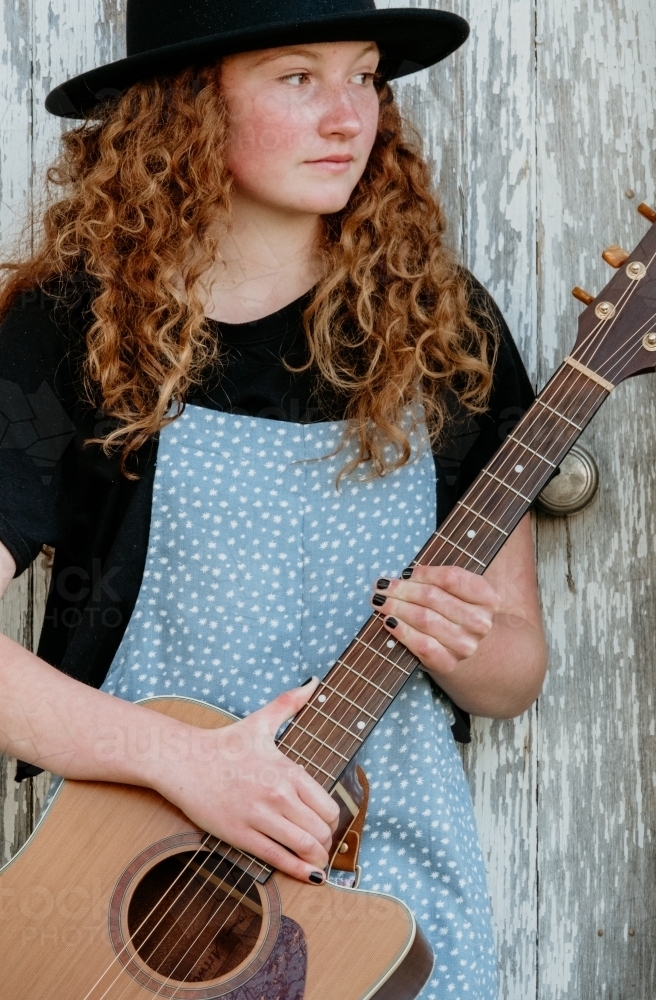 Young teenage girl with guitar. - Australian Stock Image