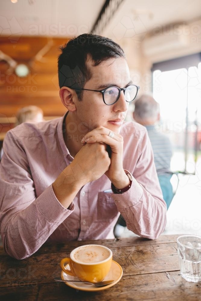 Young well dressed male with coffee in a cafe - Australian Stock Image