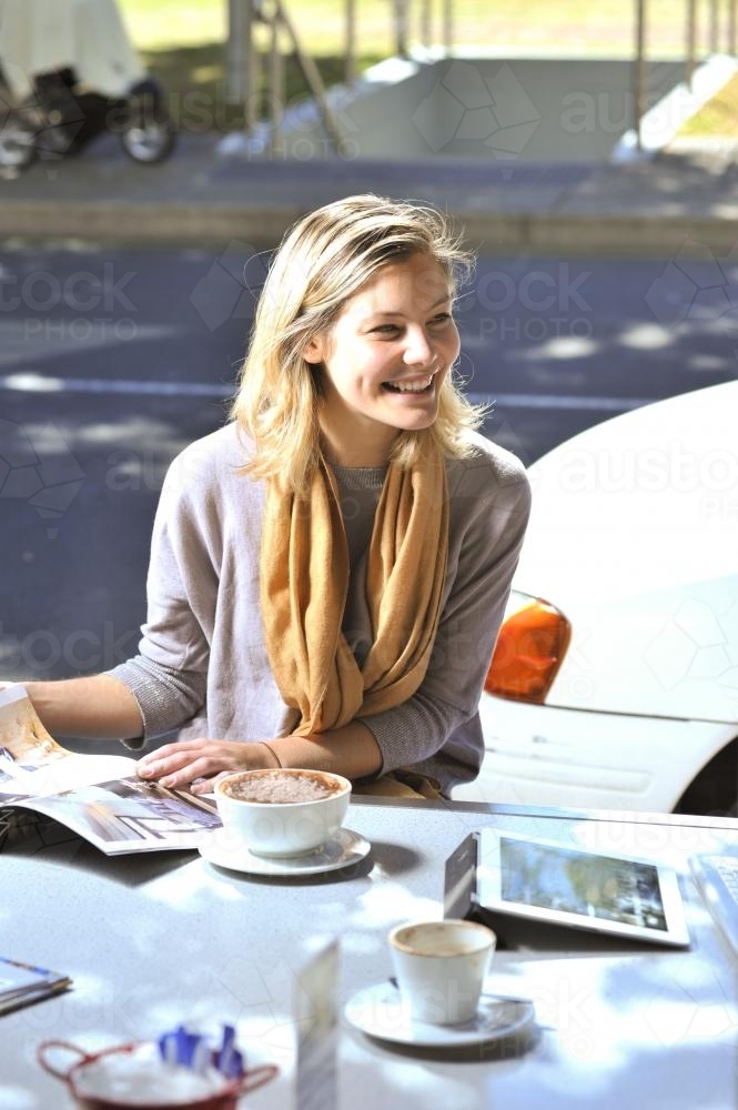 young woman at a cafe outdoors - Australian Stock Image
