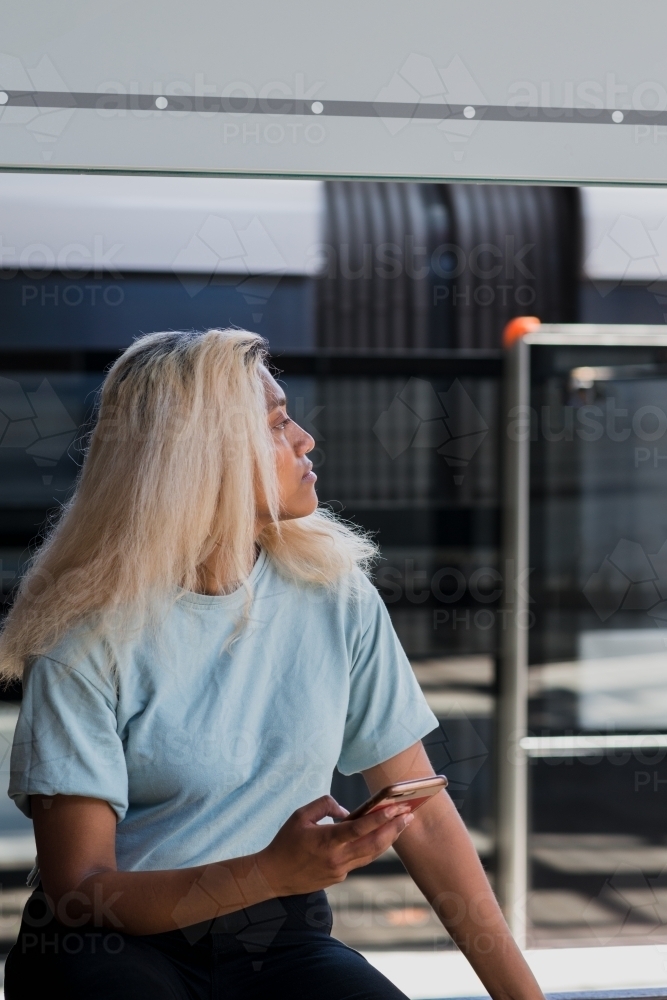 young woman at the train station - Australian Stock Image