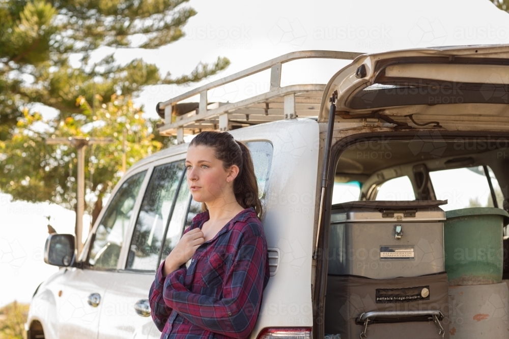 Young woman by herself with 4WD and camping gear - Australian Stock Image