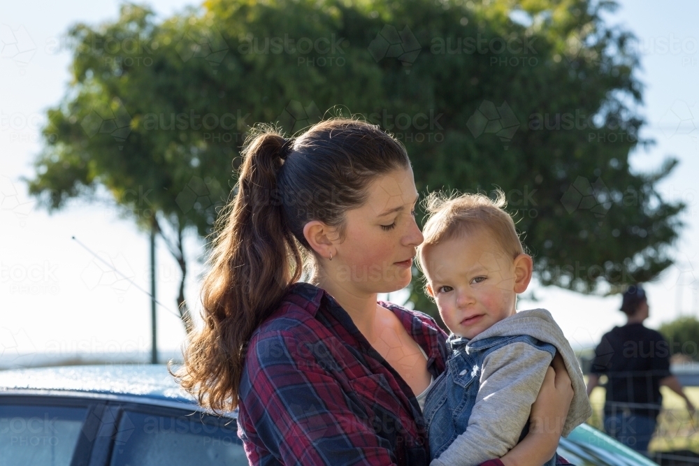 Young woman holding a toddler - Australian Stock Image