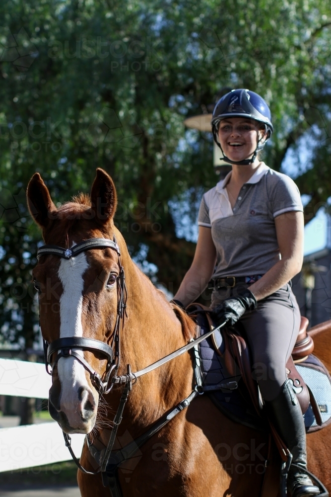 Young woman horse riding in park - Australian Stock Image