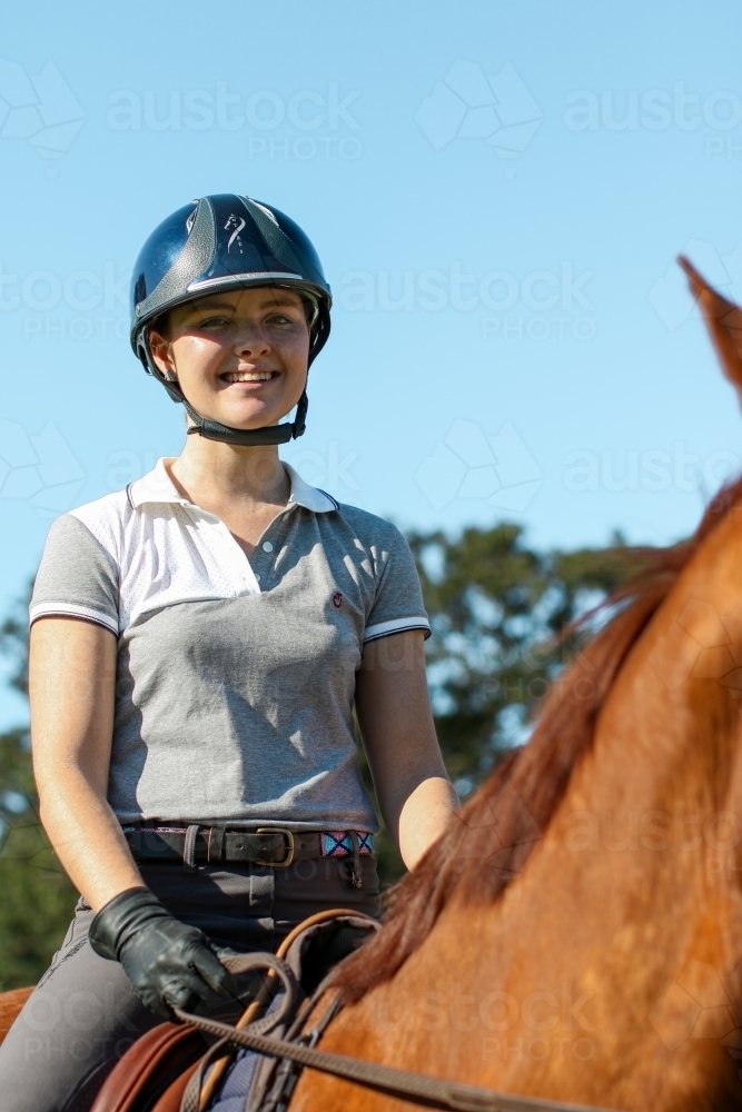 Young woman horse riding in park - Australian Stock Image