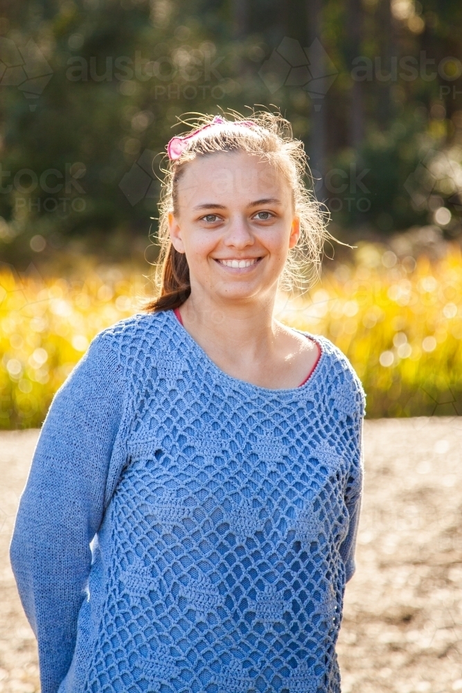 Young woman in her early twenties smiling at camera - Australian Stock Image