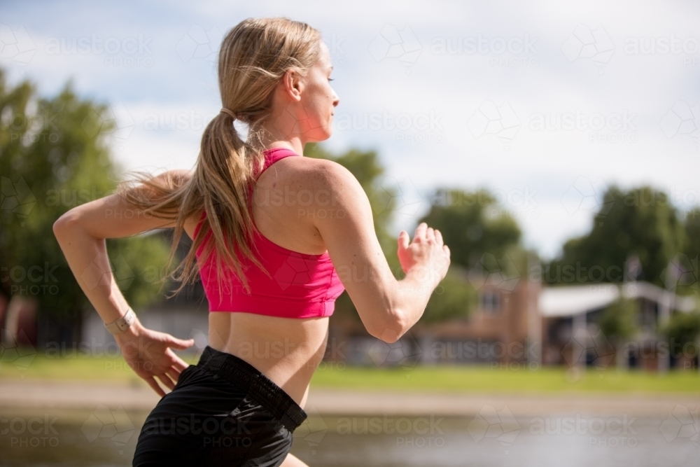 Young Woman Jogging by the Yarra River - Australian Stock Image