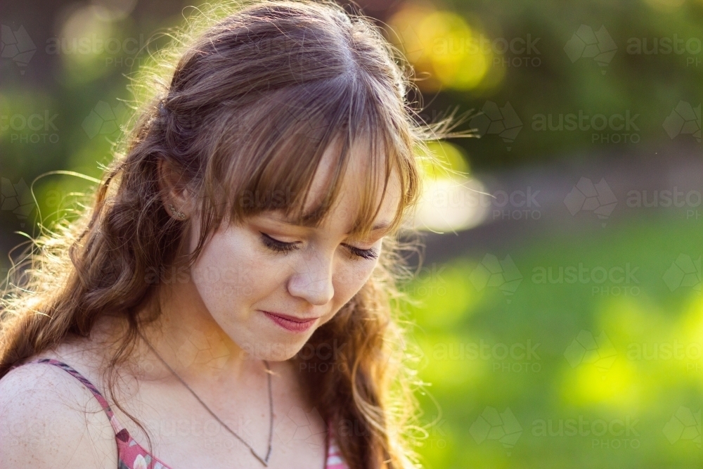 Young woman looking down - Australian Stock Image