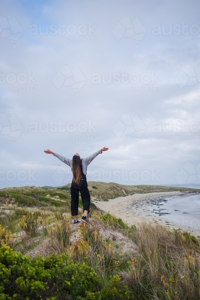 Young woman loving life by the sea - Australian Stock Image