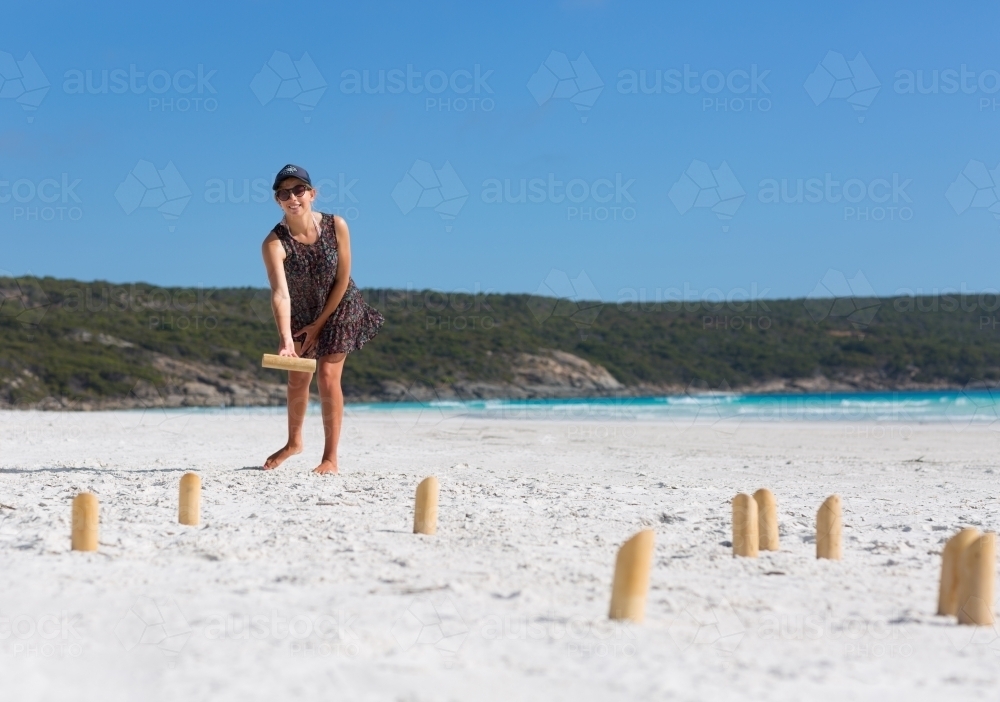Young woman playing finska game on the beach - Australian Stock Image