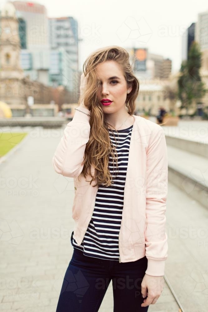 Young woman posing in the city looking at camera - Australian Stock Image