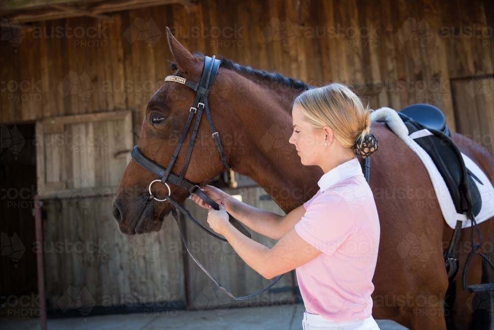 Young Woman Preparing for Horse Riding - Australian Stock Image