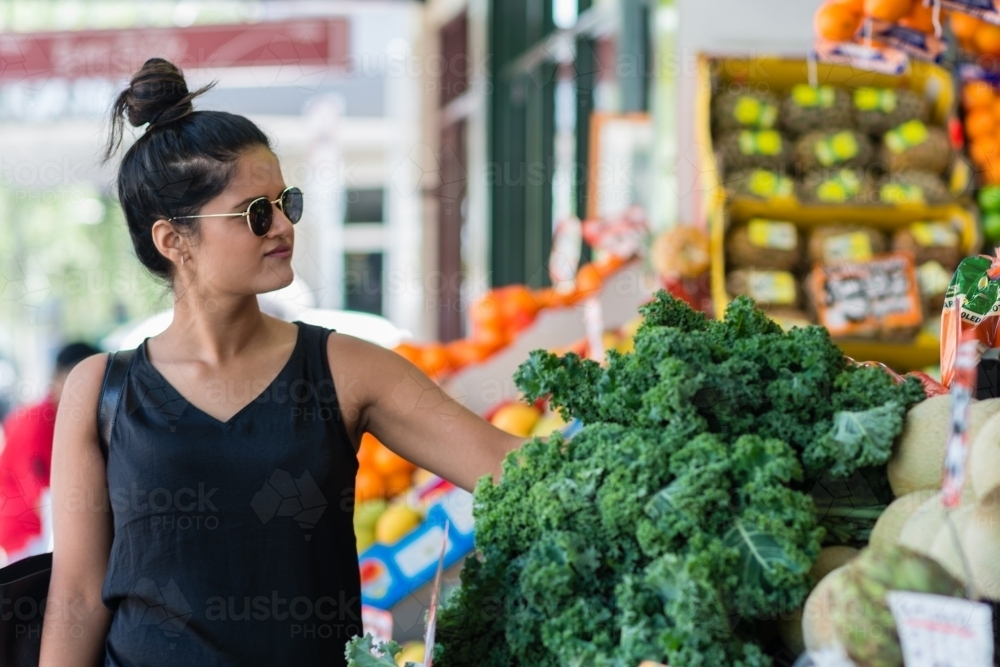 young woman shopping at local fruit and veg - Australian Stock Image