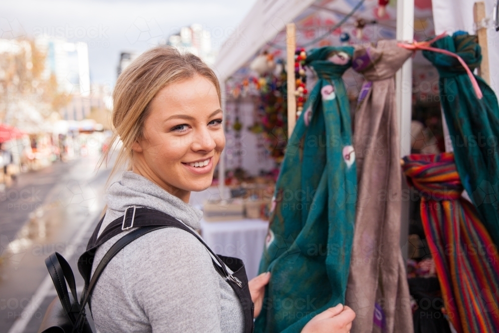 Young Woman Shopping at Outdoor Market - Australian Stock Image